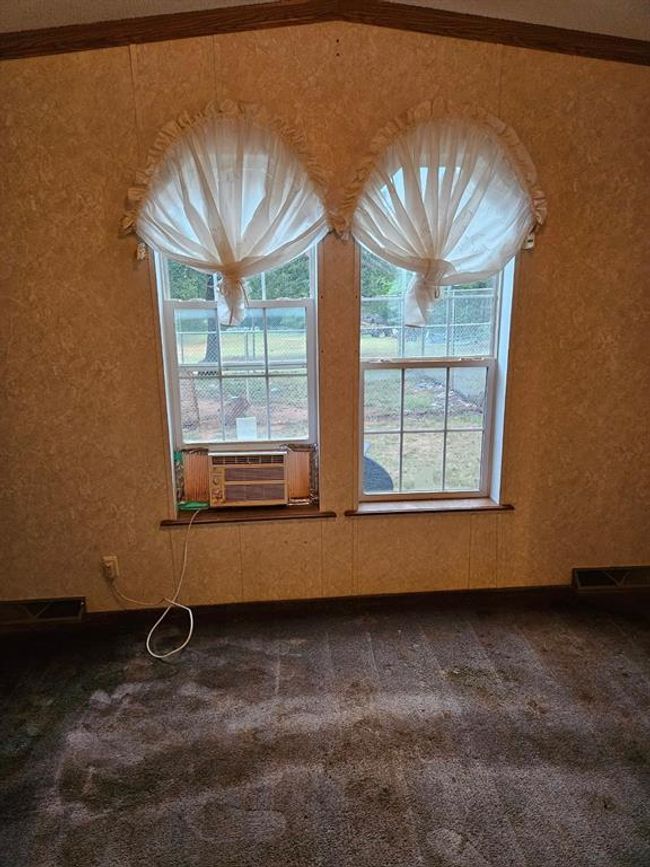 Empty room with cooling unit and carpet floors | Image 30