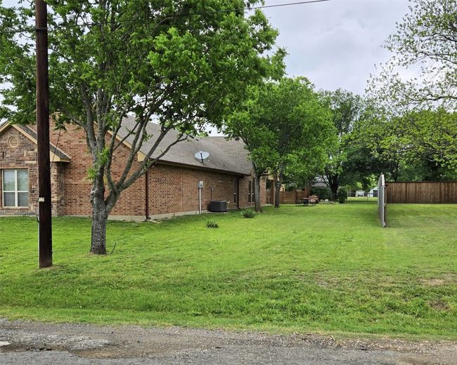 View of yard featuring fence and central air condition unit | Image 9