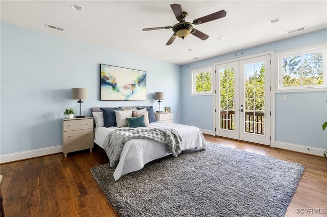 2nd floor primary suite, french doors to vesitbule, site finished hardwood floors, juliet balcony, surround sound, recessed lighting, ceiling fan with light; access to en suite and custom closet. | Image 23