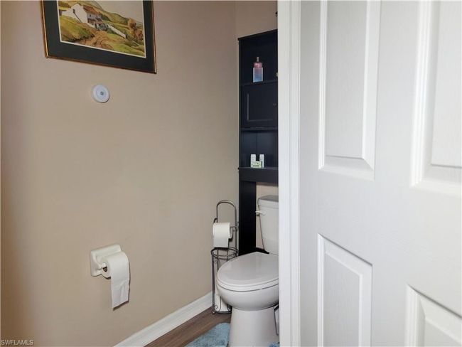 Bathroom featuring toilet, wood finished floors, and baseboards | Image 32