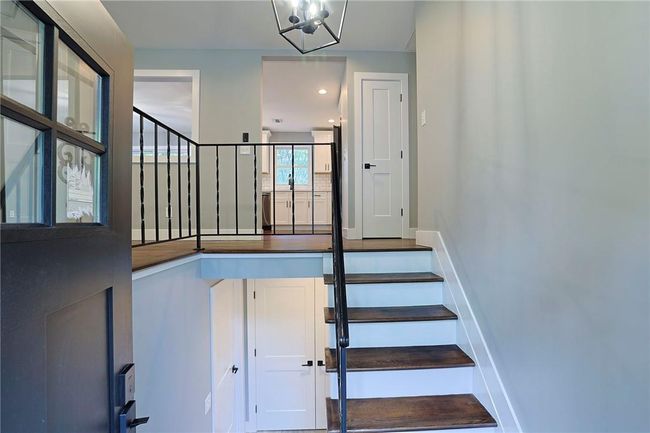 Stairway featuring an inviting chandelier | Image 28