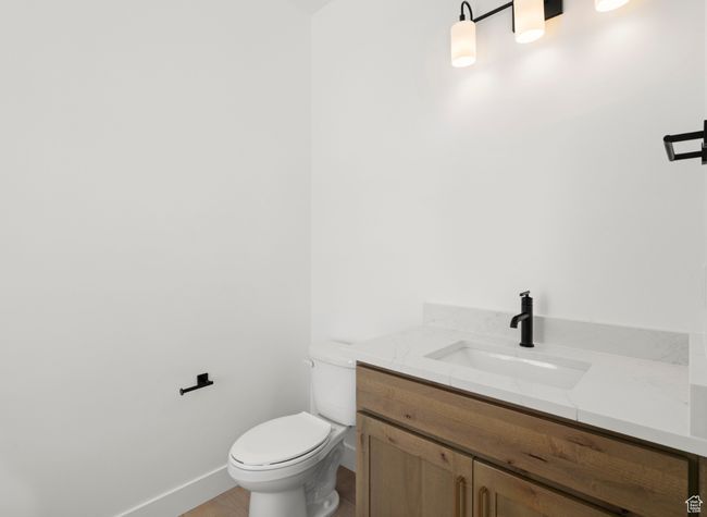 Half bath with toilet, vanity, and baseboards | Image 13