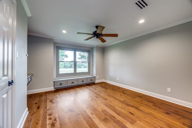 Unfurnished room featuring wood-type flooring, ceiling fan, crown molding, and recessed lighting | Image 17