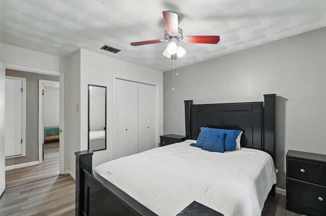 Bedroom with wood finished floors, a closet, baseboards, and a ceiling fan | Image 16