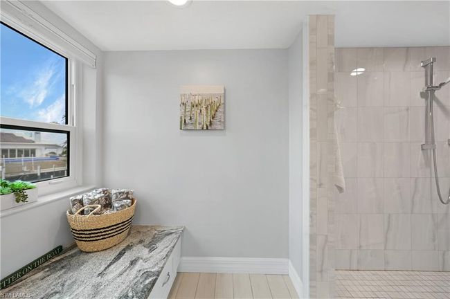 Bathroom featuring a tile shower and hardwood / wood-style flooring | Image 26