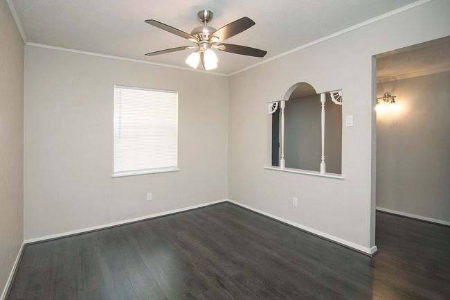 Spare room with dark hardwood / wood-style floors, ceiling fan, and crown molding | Image 11