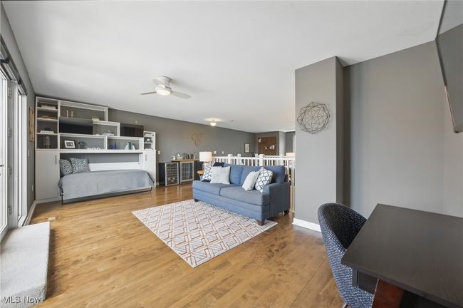 Living room featuring ceiling fan and wood finished floors | Image 32