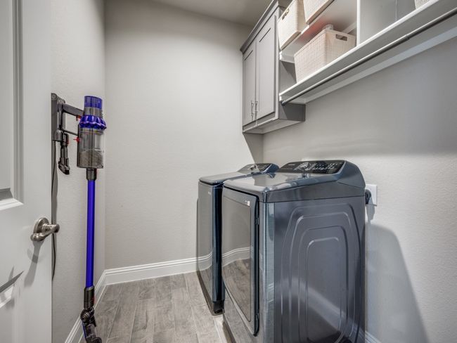 Practical and well-organized laundry room featuring extra storage and a hanging rack! | Image 23