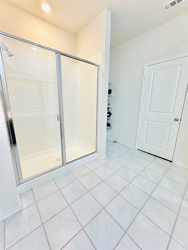 Full bathroom with a stall shower, tile patterned flooring, recessed lighting, and baseboards | Image 24