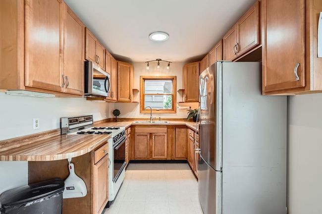 Kitchen with abundant cabinet and counter space. This small but mighty kitchen will be the perfect spot for your meal preparation! | Image 9