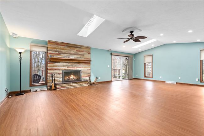 View of the great room showing the abundance of windows, skylights and access door to the deck | Image 16