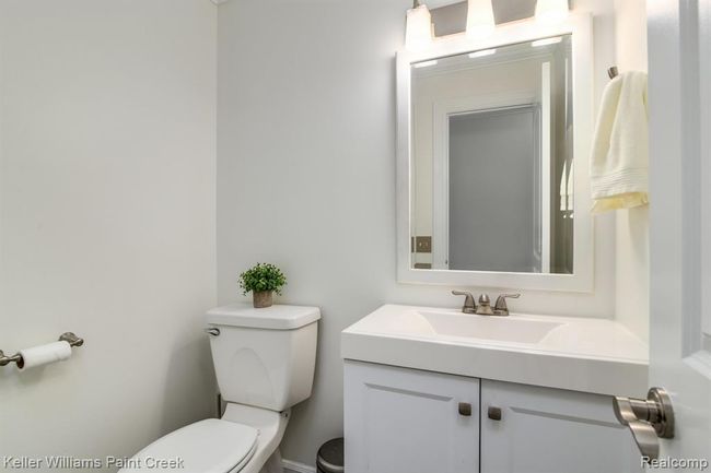 Additional bathroom features a clean look and updated flooring. | Image 12