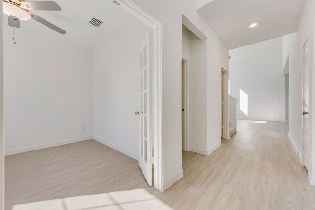 Hallway with light wood-type flooring and recessed lighting | Image 15