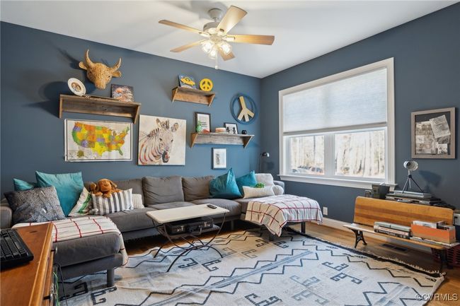Living room featuring baseboards, wood finished floors, and a ceiling fan | Image 30