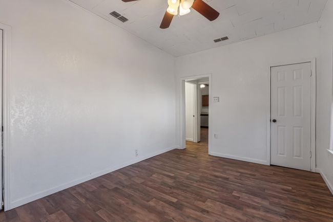 Empty room with ceiling fan and dark hardwood / wood-style flooring | Image 26