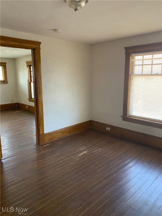 Unfurnished room with dark wood-type flooring and a smoke detector | Image 11