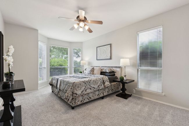 Carpeted bedroom with a ceiling fan and baseboards | Image 20