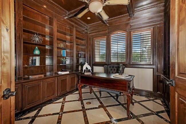 Formal office just off the primary bedroom has custom woodwork | Image 25