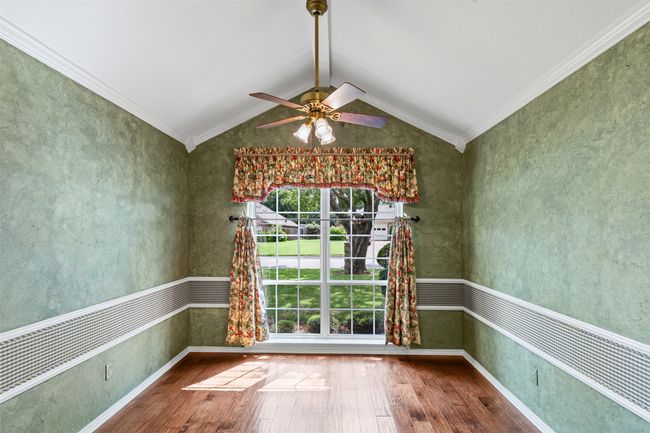 Breakfast area featuring wood-type flooring, ceiling fan, and crown molding | Image 9