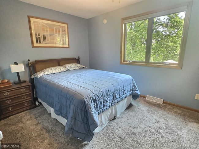 The primary bedroom also offers great views of the lake and is located across the hall from a full bathroom. | Image 23