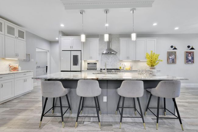 A striking view of the spacious island, designed to anchor the kitchen with both beauty and purpose. | Image 16
