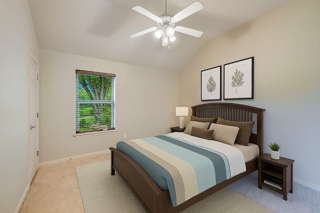 Bedroom featuring light colored carpet, vaulted ceiling, and a ceiling fan | Image 31