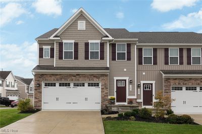 Craftsman-style home with a front lawn and a garage | Image 1