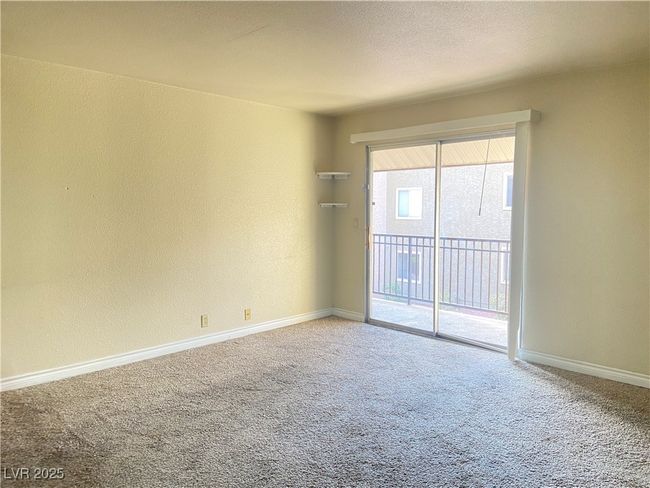 Spare room featuring carpet, baseboards, and a textured wall | Image 6