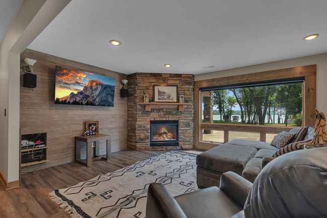 Bright, open living room with fireplace and water views. | Image 17