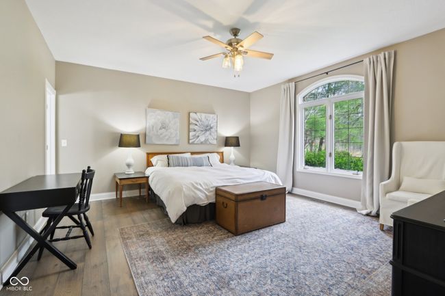 bedroom featuring baseboards, ceiling fan, and wood finished floors | Image 32