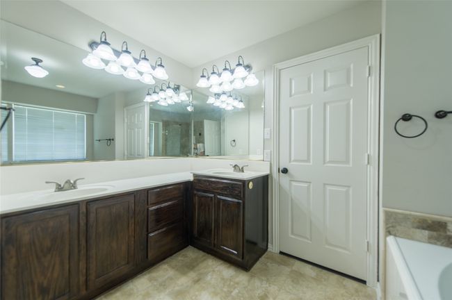 Full bath with double vanity, a shower with door, and a bath | Image 32