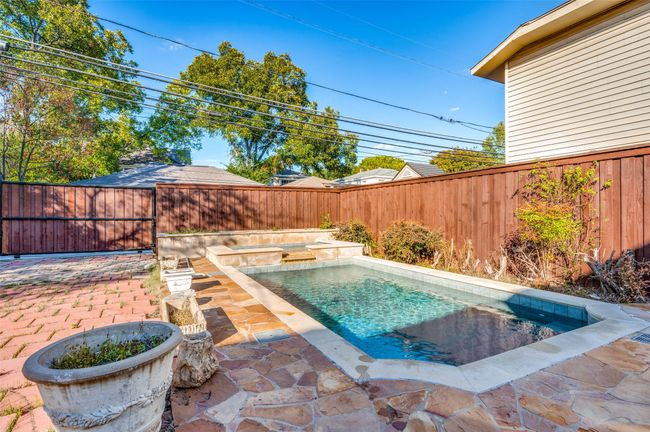 View of pool with a fenced backyard, a patio, and a pool with connected hot tub | Image 34