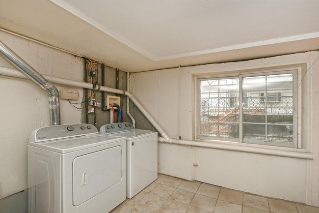 Clothes washing area with washing machine and clothes dryer and laundry area | Image 11