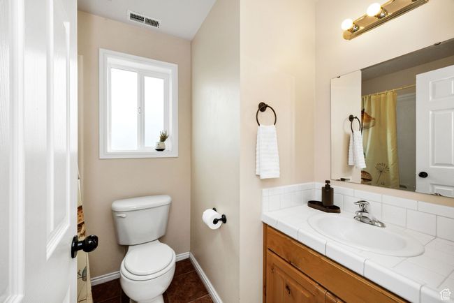 Upstairs Bathroom featuring tub/shower combo, toilet, baseboards, tile patterned floors, and vanity | Image 16