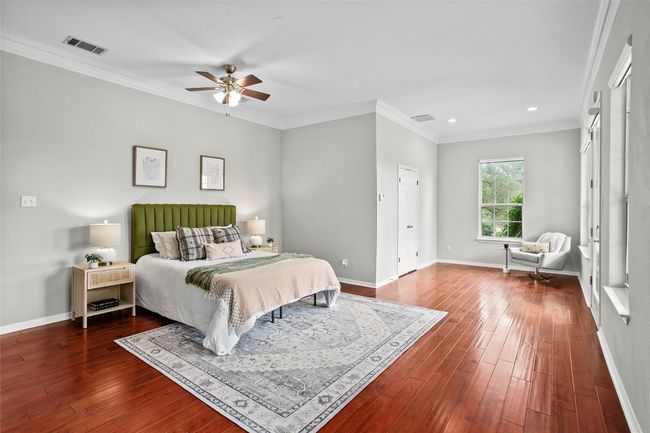 Oversized primary bedroom with wood floors and lovely sitting area | Image 15