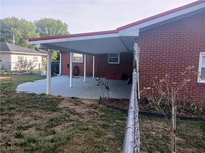 Rear view of property featuring a lawn and a patio | Image 3