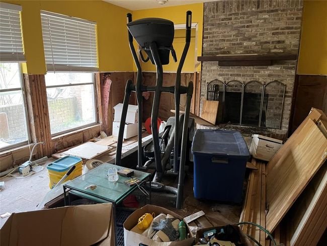 Living area and fireplace downstairs. | Image 27
