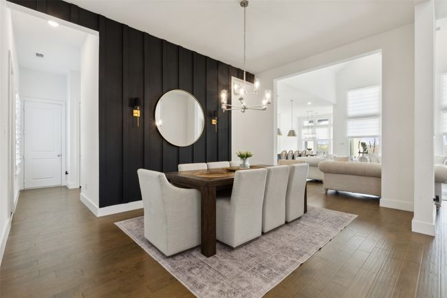 Dining space with a chandelier, dark wood-style floors, and baseboards | Image 8