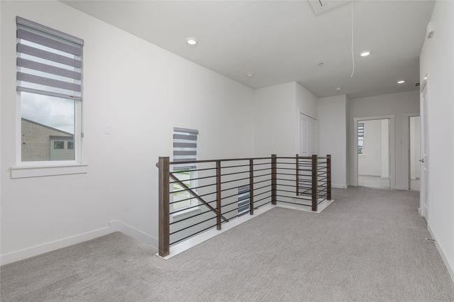 Hallway with an upstairs landing, attic access, carpet flooring, and recessed lighting | Image 12