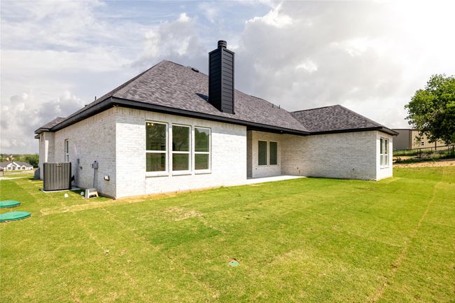 Rear view of house with central AC unit and a yard | Image 38