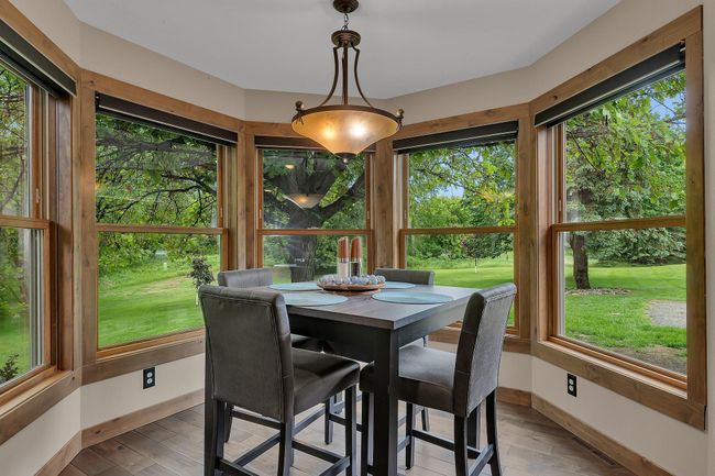 Enjoy meals in a sunlit dining cove that adds warmth and character to the home. | Image 13