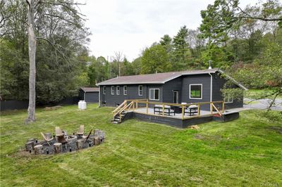 Back of property with a lawn and an outdoor fire pit | Image 3