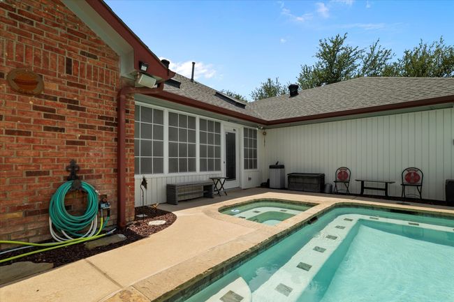 Swimming pool featuring an in-ground hot tub and a patio | Image 31