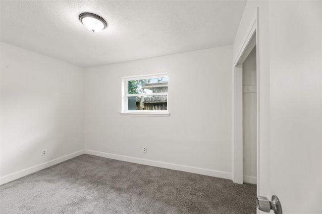 Secondary bedroom with neutral tones and cozy appeal. | Image 21