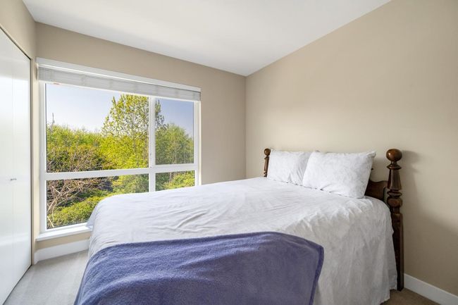 Bedroom with carpet, baseboards, and multiple windows | Image 15