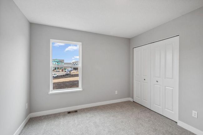 Spacious secondary bedroom with natural light. Model photos. Options and colors will vary. | Image 34