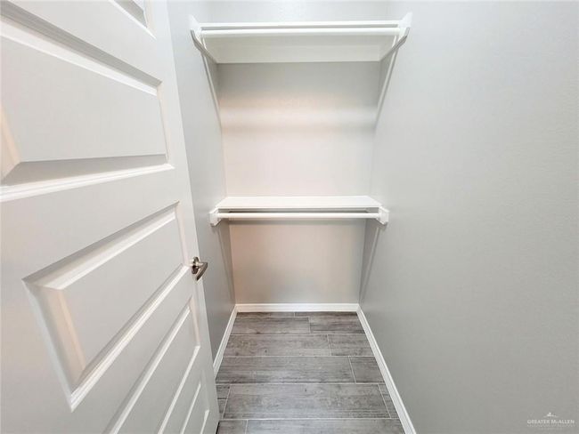 Spacious closet featuring wood finished floors | Image 13