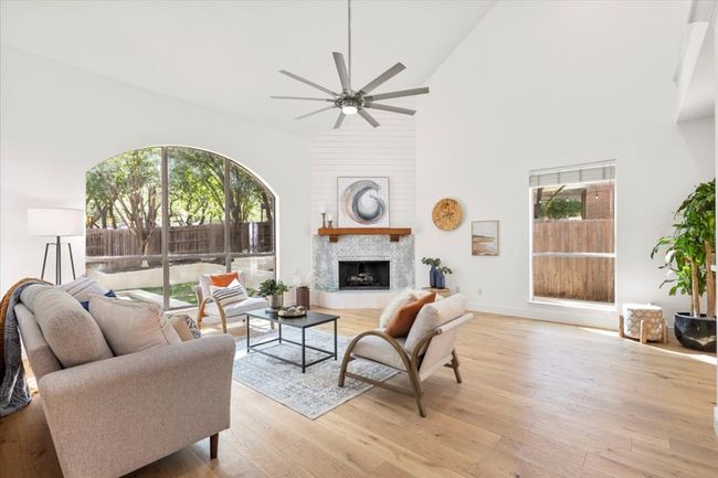 Living room with high ceilings, large windows overlooking the backyard | Image 7