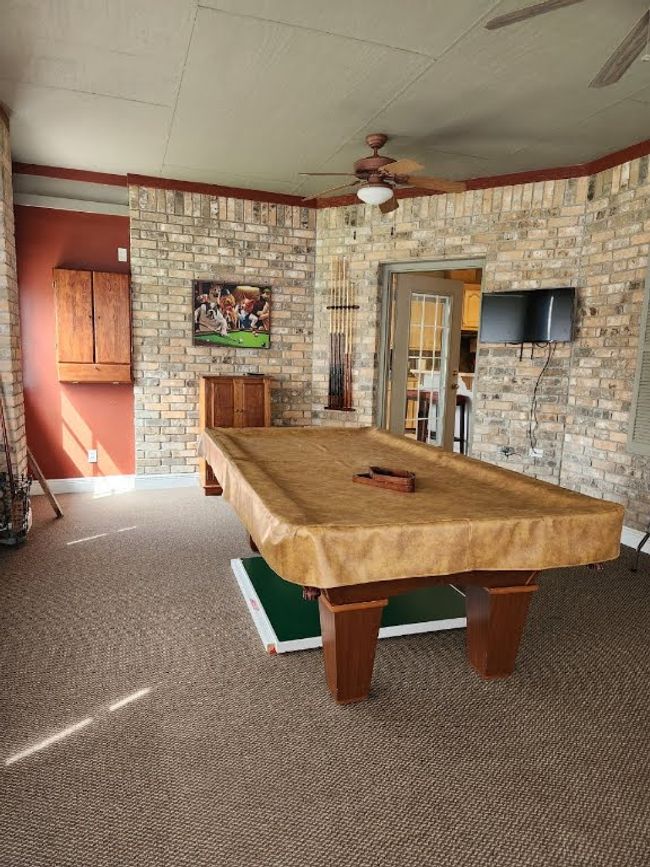 Rec room with ceiling fan, carpet floors, pool table, and ornamental molding | Image 26