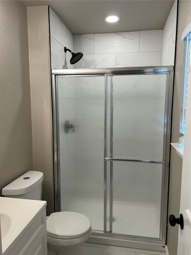 Bathroom featuring vanity, a stall shower, toilet, and recessed lighting | Image 27